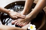 A close-up of hands washing a person's feet  Description automatically generated with low confidence